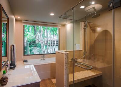 Modern bathroom with large window, bathtub, and shower