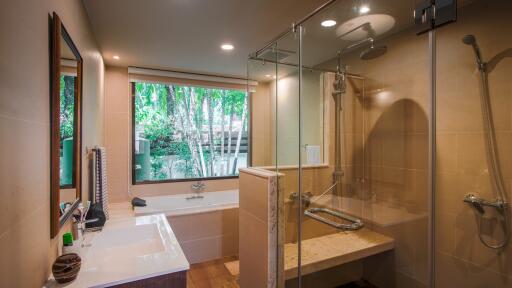 Modern bathroom with large window, bathtub, and shower