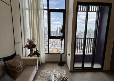 Modern living room with tall windows and city view