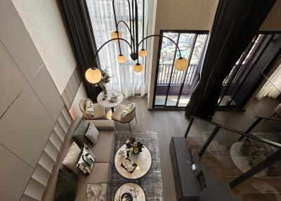 Aerial view of a modern living room with large windows, stylish furniture, and a chandelier