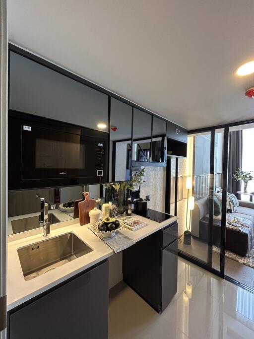 Modern compact kitchen with high gloss cabinets and integrated appliances