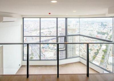 Spacious living area with large windows offering panoramic city views