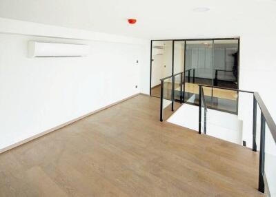 Bright open main living space with wooden flooring and air conditioning