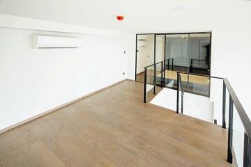 Bright open main living space with wooden flooring and air conditioning