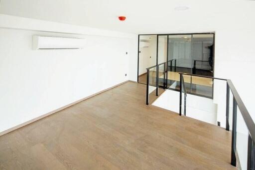 Bright open main living space with wooden flooring and air conditioning