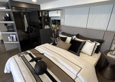 Modern bedroom with bed, bedside tables, and built-in storage