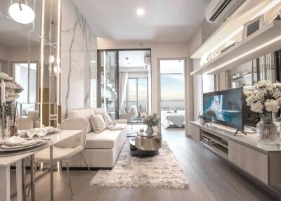 Modern living room with a cozy sofa, dining area, and a view of the city through the balcony