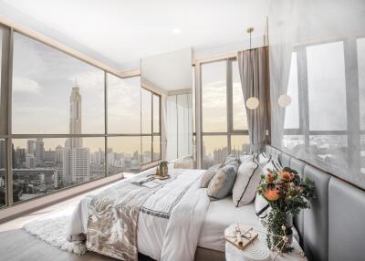 Modern bedroom with large windows and city view