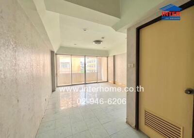 Vacant living room with tiled flooring and balcony access