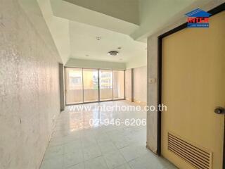 Vacant living room with tiled flooring and balcony access