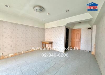 Empty room with tiled floor and floral wallpaper