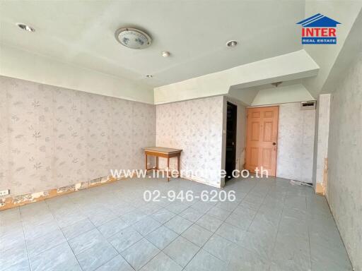 Empty room with tiled floor and floral wallpaper