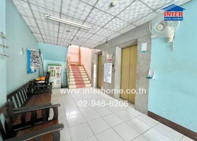 Entrance hallway with seating area and staircase