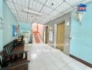 Entrance hallway with seating area and staircase