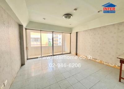 Spacious living area with large windows and balcony access