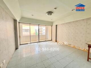 Spacious living area with large windows and balcony access