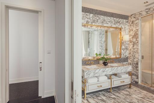 Luxury bathroom with marble countertops and gold accents