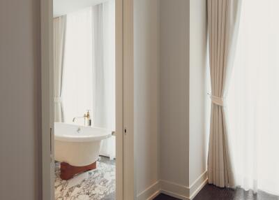 Bathroom with a view of a bathtub through a doorway