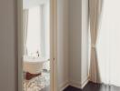 Bathroom with a view of a bathtub through a doorway