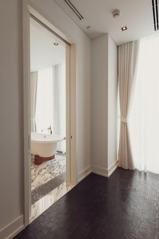 Bathroom with a view of a bathtub through a doorway