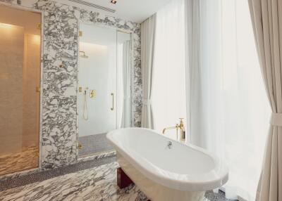 Luxurious bathroom with marble floors and freestanding bathtub