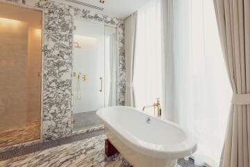 Luxurious bathroom with marble floors and freestanding bathtub