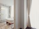 Bright marble bathroom with freestanding tub and large window