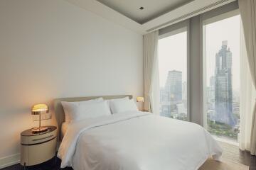 Modern bedroom with large windows and city view