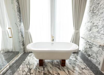 Elegant bathroom with freestanding bathtub and marble finishes