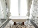 Elegant bathroom with freestanding bathtub and marble finishes