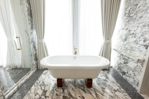 Elegant bathroom with freestanding bathtub and marble finishes