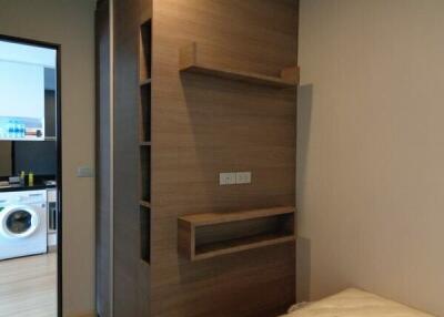 Bedroom with view into the laundry area