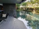 Modern outdoor pool area with seating and greenery