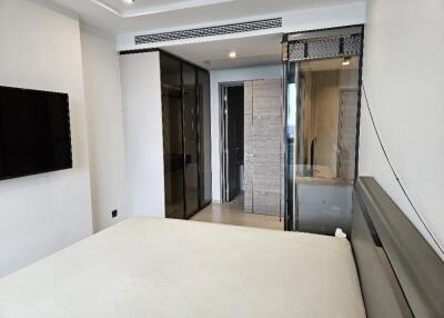 Modern bedroom with glass doors and ensuite bathroom