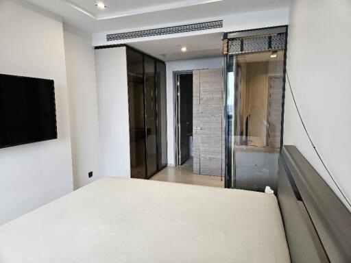 Modern bedroom with glass doors and ensuite bathroom