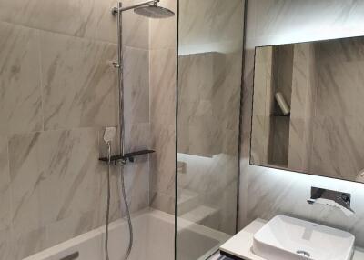 Modern bathroom with a walk-in shower and a wall-mounted sink