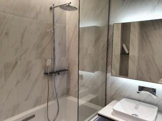 Modern bathroom with a walk-in shower and a wall-mounted sink