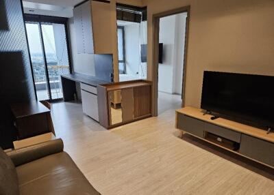 Modern living area with natural light and balcony access