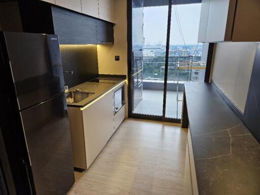 Modern kitchen with appliances and city view from balcony