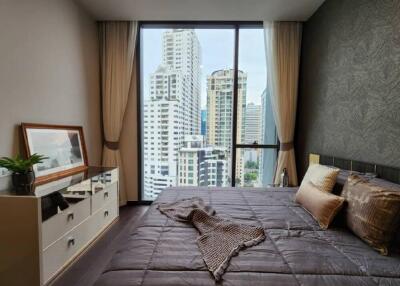 Bedroom with large glass window and city view