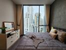 Bedroom with large glass window and city view