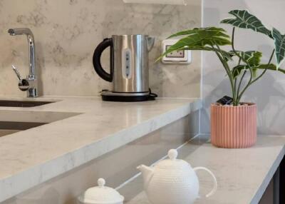 Modern kitchen with marble countertop and tea set