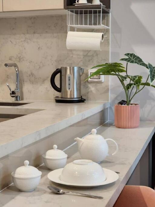 Modern kitchen with marble countertop and tea set