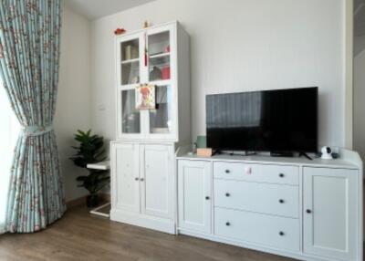 Living room with white cabinets and TV