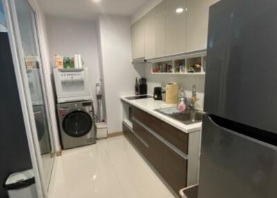 Modern kitchen with appliances and laundry area