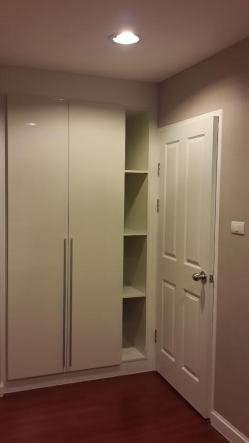 Bedroom with built-in closet and shelving