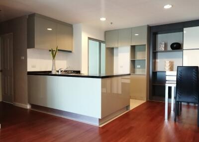 Modern kitchen with sleek cabinets and wooden flooring