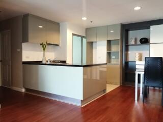 Modern kitchen with sleek cabinets and wooden flooring