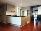 Modern kitchen with sleek cabinets and wooden flooring