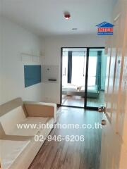 Living room with sofa and sliding glass door to bedroom